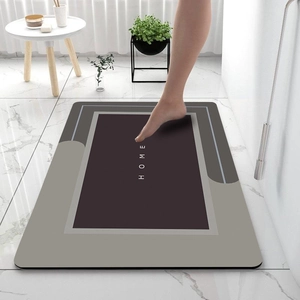 Detailed view of modern geometric diatom mud bath mat with HOME text and non-slip texture