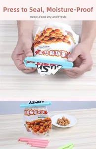 Close-up of colorful plastic food sealing clips for snack bags on light wood background