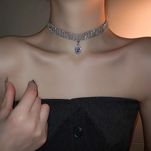Sparkling silver rhinestone choker with an elegant oval pendant worn by a model