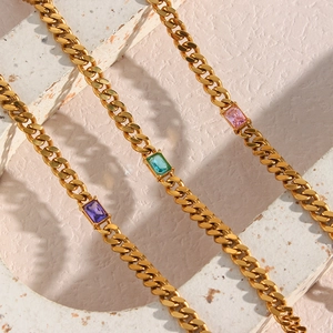 Detailed macro view of 6.5mm gold Cuban link necklaces with rectangle zircon gemstones