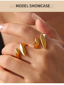 Detail shot of elegant gold-plated titanium open rings with unique leaf-shaped design