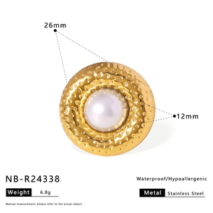 Detailed macro of 26mm gold hammered ring with 12mm white pearl inlay on white background