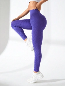 Detailed view of high-waisted purple yoga leggings featuring seamless diamond jacquard texture