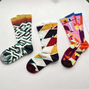 Detailed flat lay of three vibrant French oil painting style socks with geometric patterns