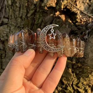 Close-up of handmade crystal crown with smokey quartz, silver moon and star details