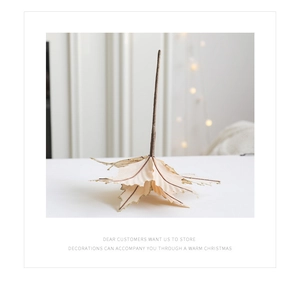 Detail of cream artificial Christmas leaves with gold glitter edges for holiday decor