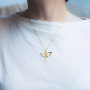 Elegant gold S925 silver necklace featuring a Cupid arrow pendant with sparkling zirconias