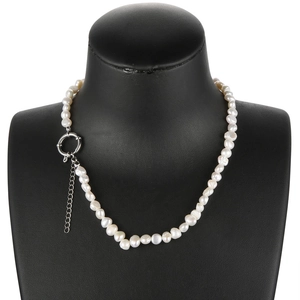 Close-up of baroque irregular freshwater pearl necklace with silver OT clasp on mannequin
