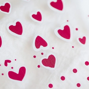 Mesh texture magenta heart nail stickers on white knit fabric for DIY manicure art