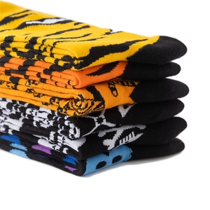 Detail showing stacked thick knit socks with vibrant tiger and zebra animal patterns