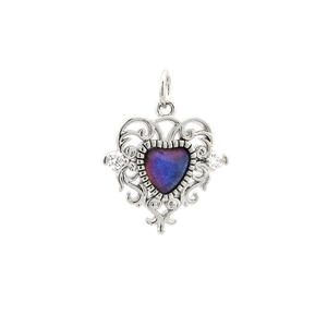 Detailed macro of vintage purple-blue heart pendant with silver hollow carved frame