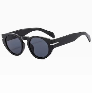 Macro view of black round frame sunglasses featuring silver arrow metal hinge accents