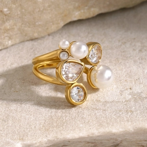 Detail of 18k gold plated open ring featuring white pearls and marquise cut zircons