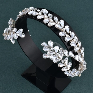 Detailed close-up of bridal crystal headband featuring silver leaf and water-drop designs