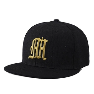 Black snapback hat with gold gothic embroidery and flat brim in street style fashion