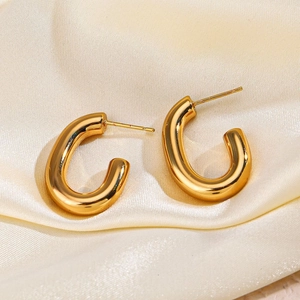 Polished 18K gold plated stainless steel C-shaped earrings on elegant champagne satin