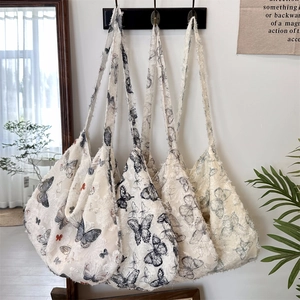 Close-up of lace butterfly tote bag showing 3D fringe texture and artistic patterns