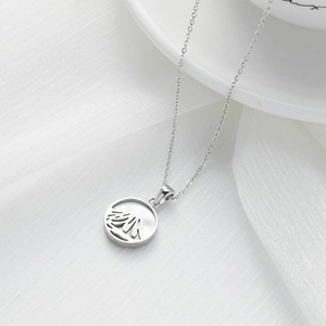 Silver stainless steel Mt. Fuji shell pendant necklace for women on white fabric