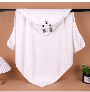 Macro shot of white hooded baby bath towel with cute bear face embroidery detail