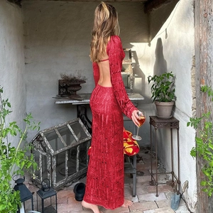 Detail of red knit dress showing backless design and hollow texture in sunlit patio
