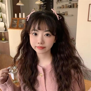 Close-up of pink bow hair clip worn by a girl for a sweet and stylish hairstyle