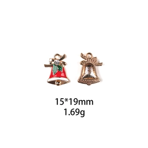 Detail view of 15x19mm gold Christmas bell charms with red and green enamel and crystal