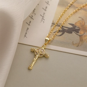 Macro detail of gold-plated crucifix necklace with耶稣 icon and shimmering white zircons