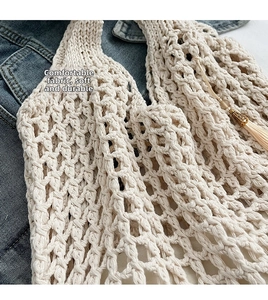 Detail view of cream crochet beach tote with diamond mesh texture and gold tassel