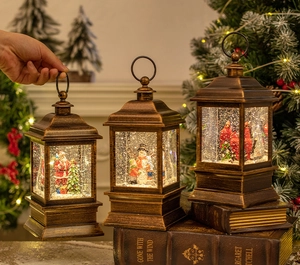 Vintage bronze Christmas lanterns with snow globe scenes on books with warm lights