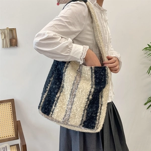 Detail of soft striped plush tote bag showing large capacity fuzzy fabric texture