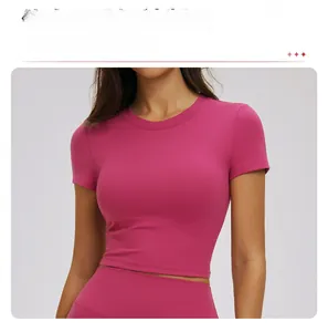 Close-up of slim-fit magenta yoga top showing high-stretch fabric and contoured waist