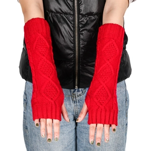 Detail of red cable-knit long fingerless gloves with diamond patterns and ribbed cuffs