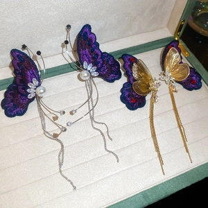 Elegant butterfly tassel earrings with purple embroidery, pearls, and gold openwork style