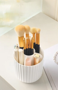 Detail of white 360 rotating makeup brush holder with 5 compartments for cosmetic storage