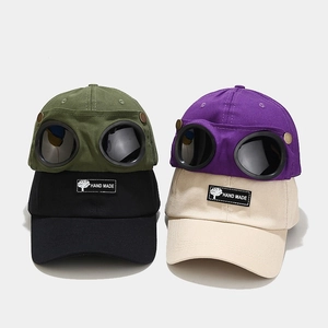 Detail of creative goggles baseball caps in green purple black and beige cotton fabric