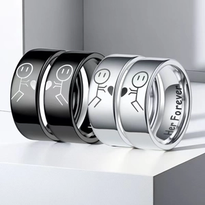 Detail of black and silver stainless steel couple rings with matching stickman heart design