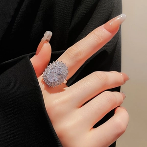 Macro detail of silver plated oval zircon ring with pavé stones on model hand