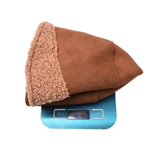 Detail showing the 105g lightweight reversible lamb wool bucket hat on a scale