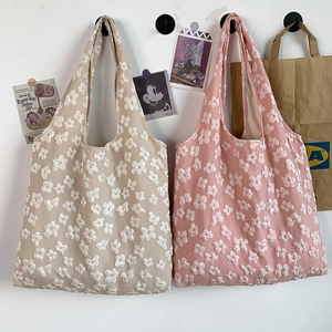 Detail of Korean lace canvas bags with 3D floral embroidery in beige and pink