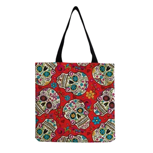 Detailed texture of red canvas tote bag featuring Mexican sugar skull floral prints
