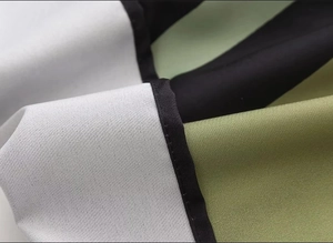 Detail of fabric stitching in grey, black, and olive green with clean edge seam work