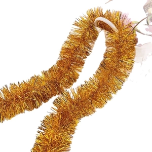 Golden tinsel garland with metallic shine for Christmas tree and festive party decor