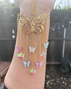 Close-up of golden butterfly suncatcher with colorful crystal stars and chains