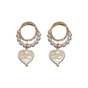 Elegant gold earrings featuring a diamond hoop and a baroque pearl heart pendant