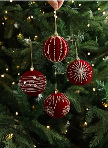 Detail of 8cm burgundy flocked Christmas balls with golden glitter patterns and warm lights