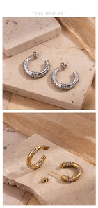 Close-up of C-shaped titanium earrings with triple rows of micro-pave crystals