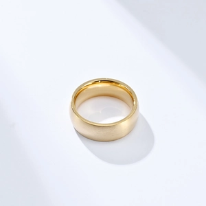 Detail of 8mm gold titanium ring featuring brushed matte surface and polished inner edge