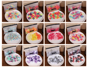 Detail showing various colors of high elastic seamless hair ties in a frosted zipper bag