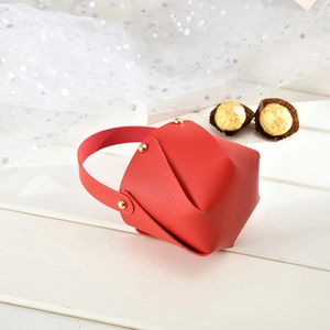 Detail of red PU leather wedding gift bag with gold rivets and white gauze decor