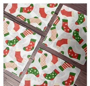 Detailed pattern of Christmas stockings with polka dots and stripes on festive napkins